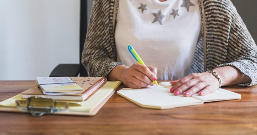 close-up-employee-writing-notebook close-up-employee-writing-notebook